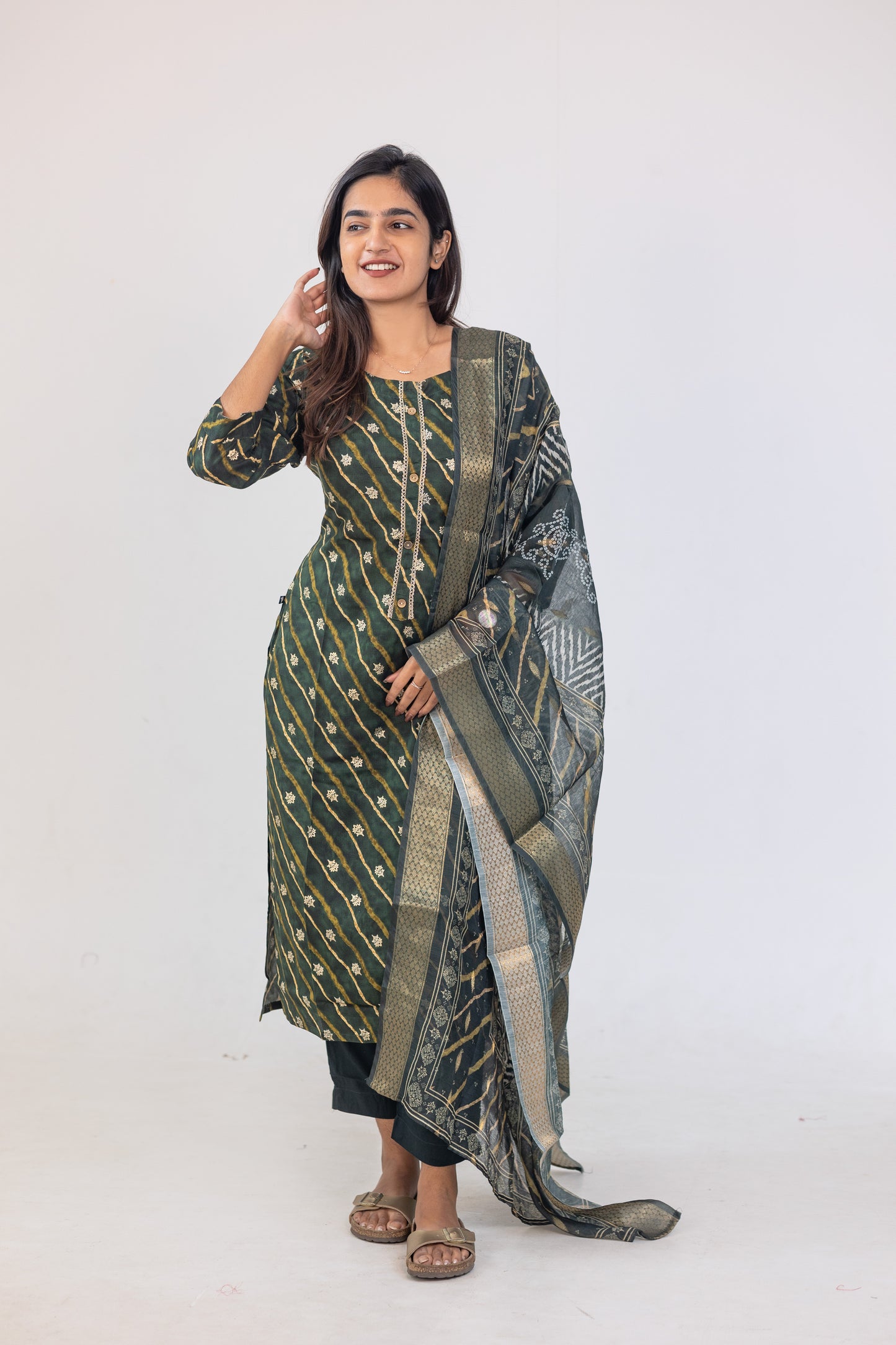 Poonguzhali salwar set in dark green