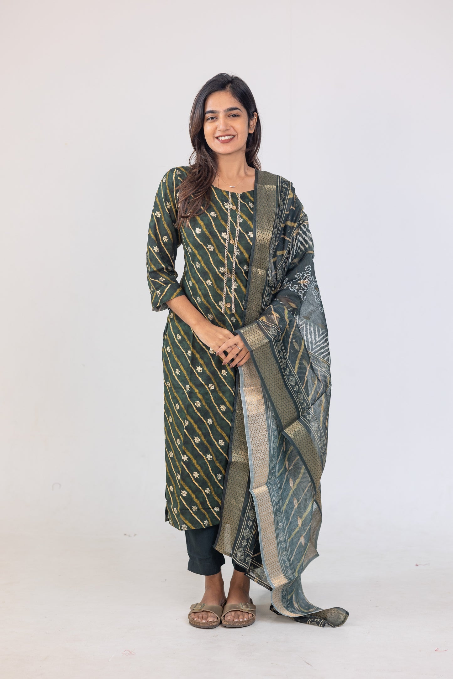 Poonguzhali salwar set in dark green