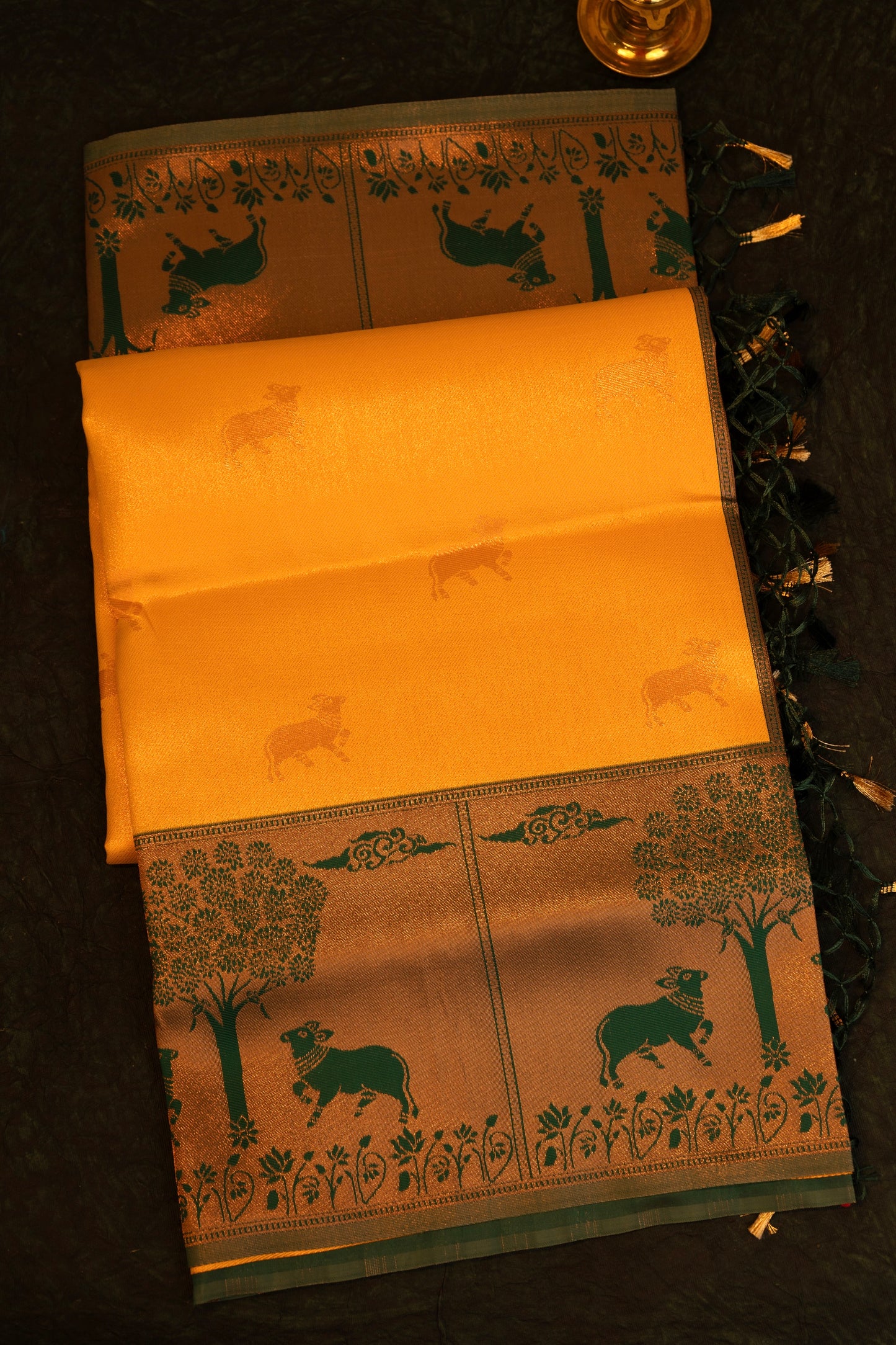 Designer saree in Mustard Yellow with Green Zari Border