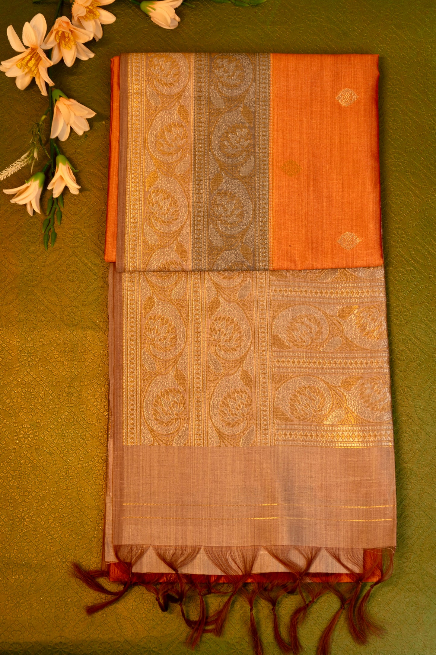 Soft silk saree in orange with Gold Zari Border