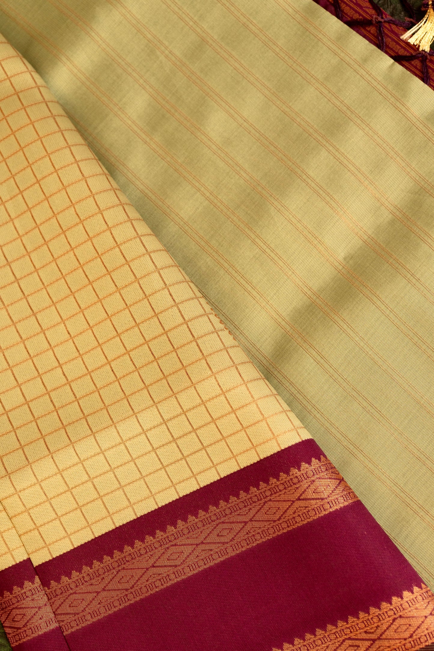 Designer saree in pale yellow with gold zari