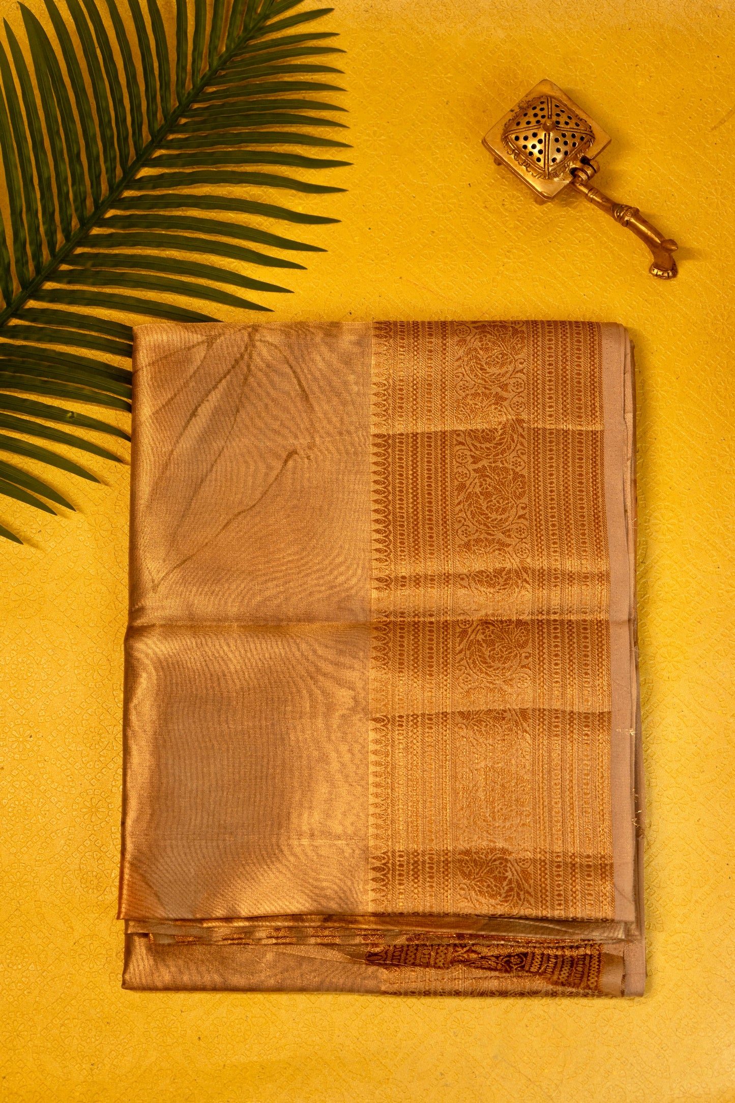 Designer saree in brown gold with floral paisley motifs
