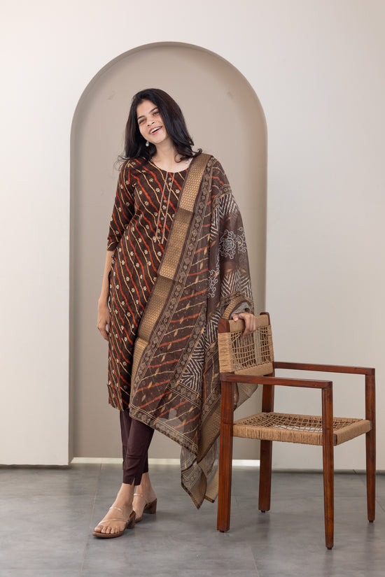 Poonguzhali salwar set in dark brown with gold printed design
