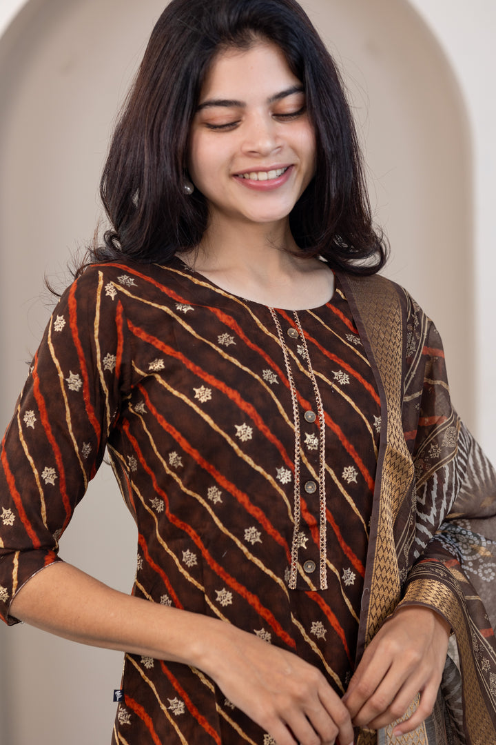 Poonguzhali salwar set in dark brown with gold printed design