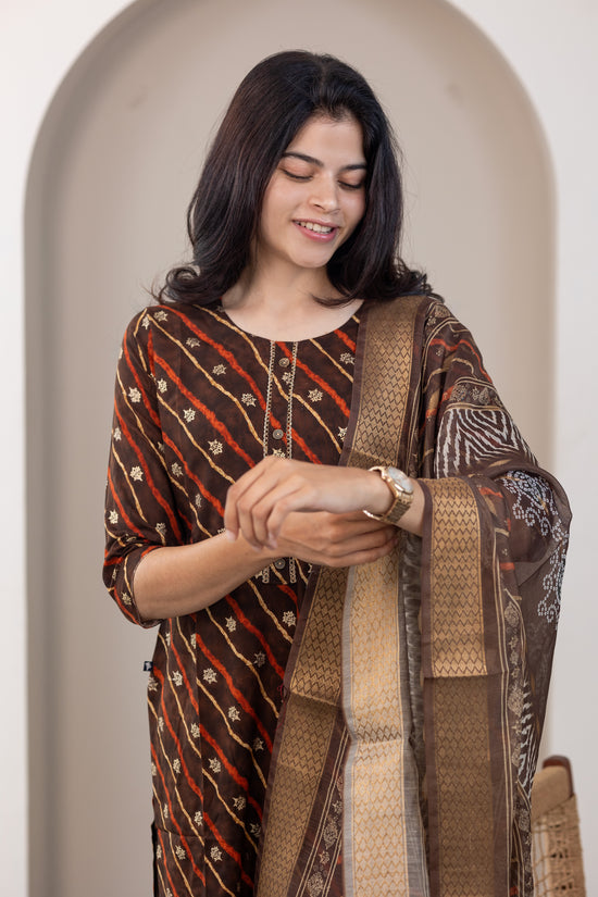 Poonguzhali salwar set in dark brown with gold printed design
