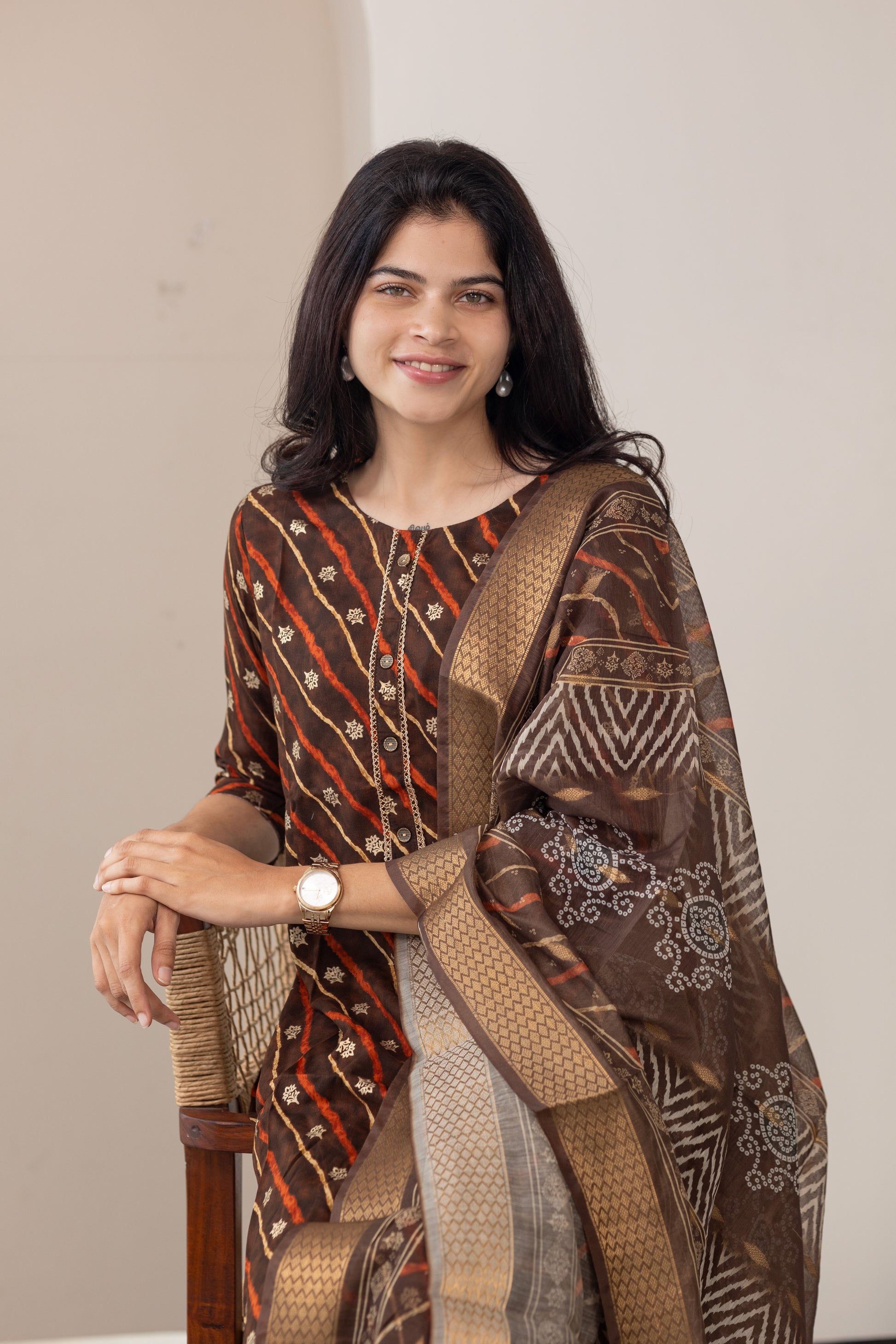 Poonguzhali salwar set in dark brown with gold printed design