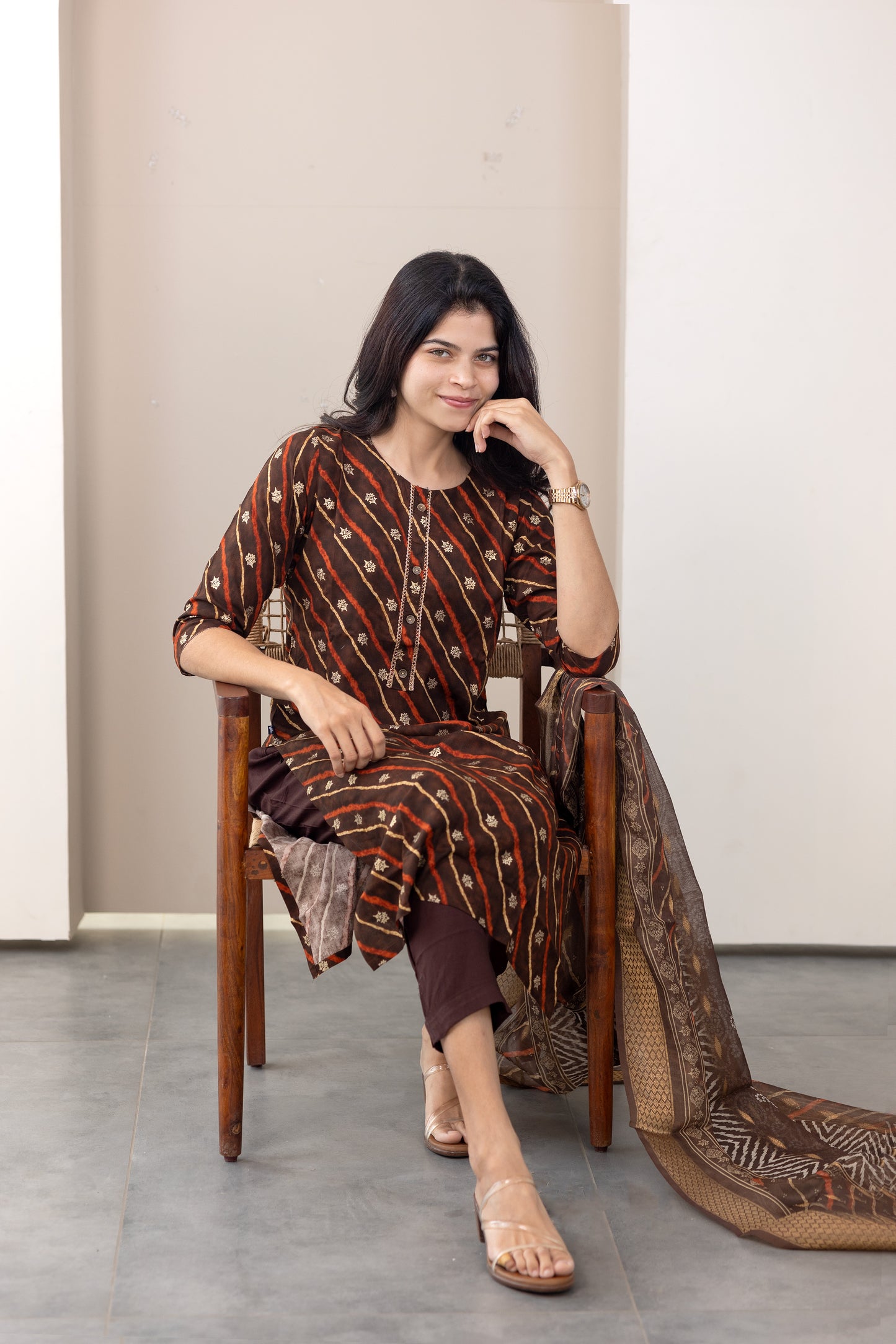 Poonguzhali salwar set in dark brown with gold printed design