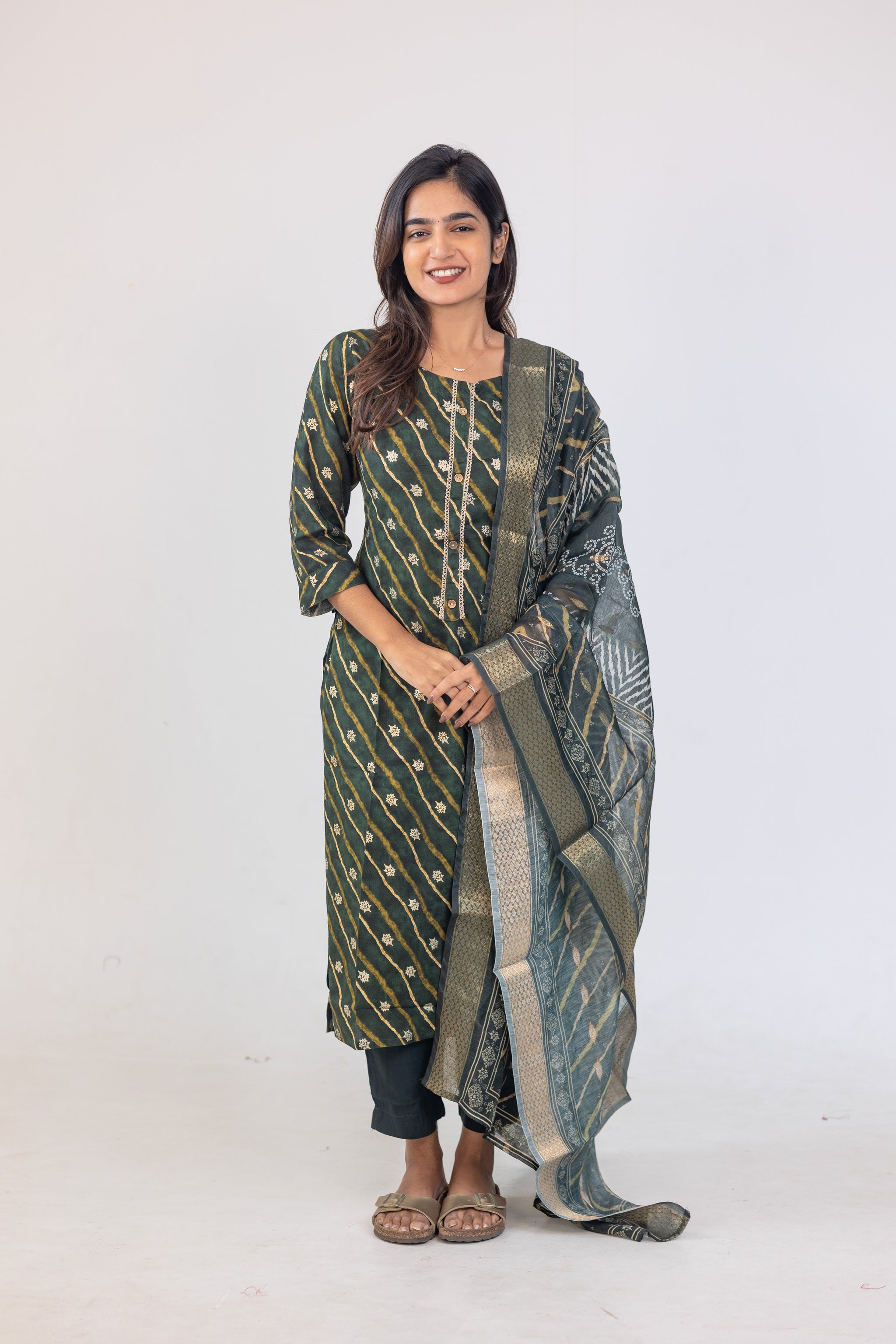 Poonguzhali salwar set in dark green