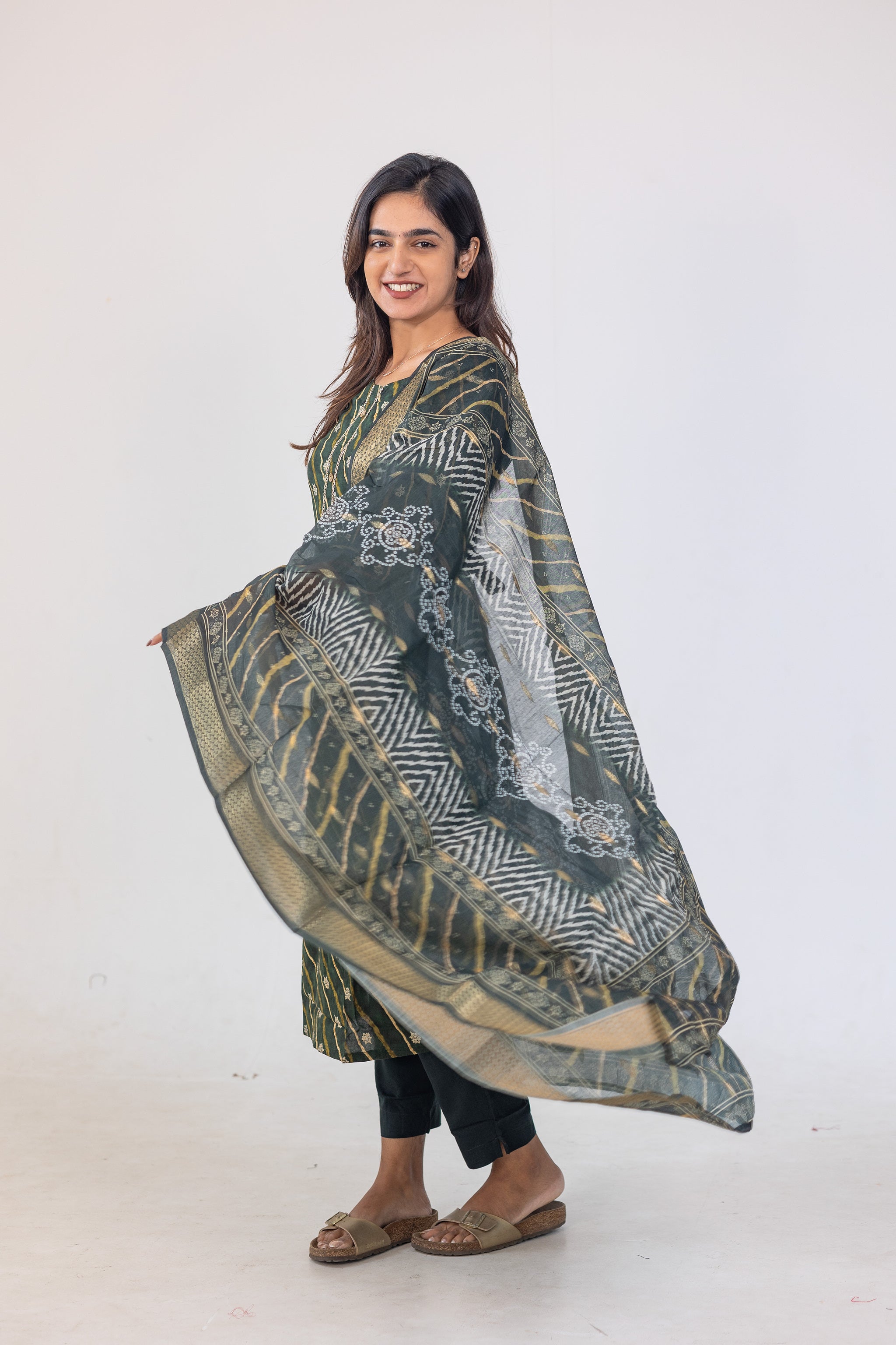 Poonguzhali salwar set in dark green