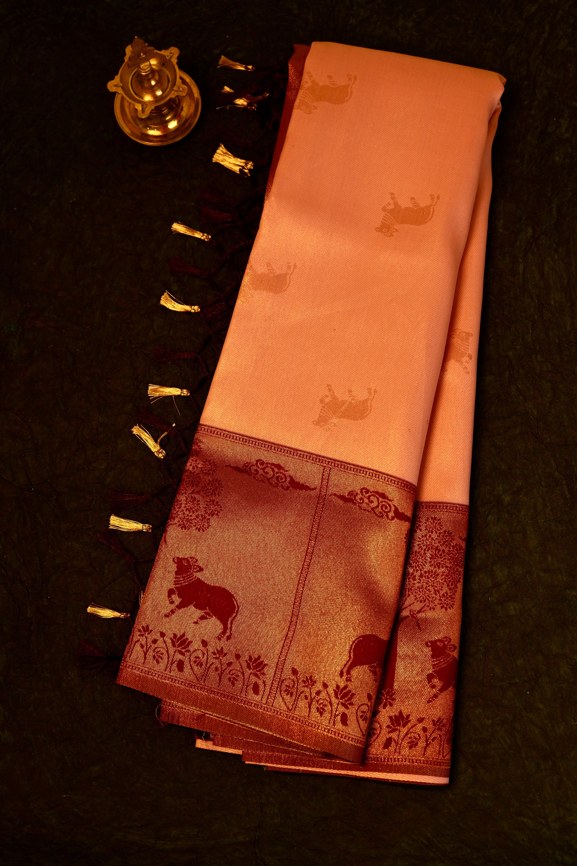 Designer saree in Peach with Maroon Zari Border