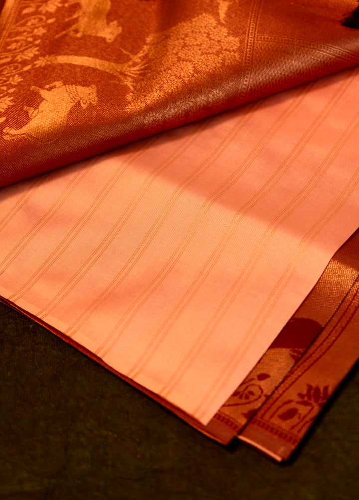 Designer saree in Peach with Maroon Zari Border