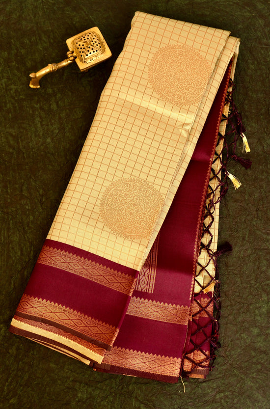 Designer saree in pale yellow with gold zari