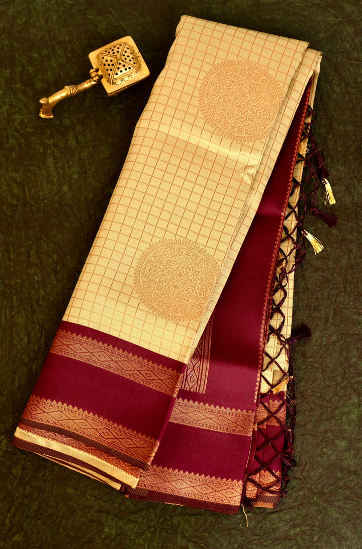 Designer saree in pale yellow with gold zari