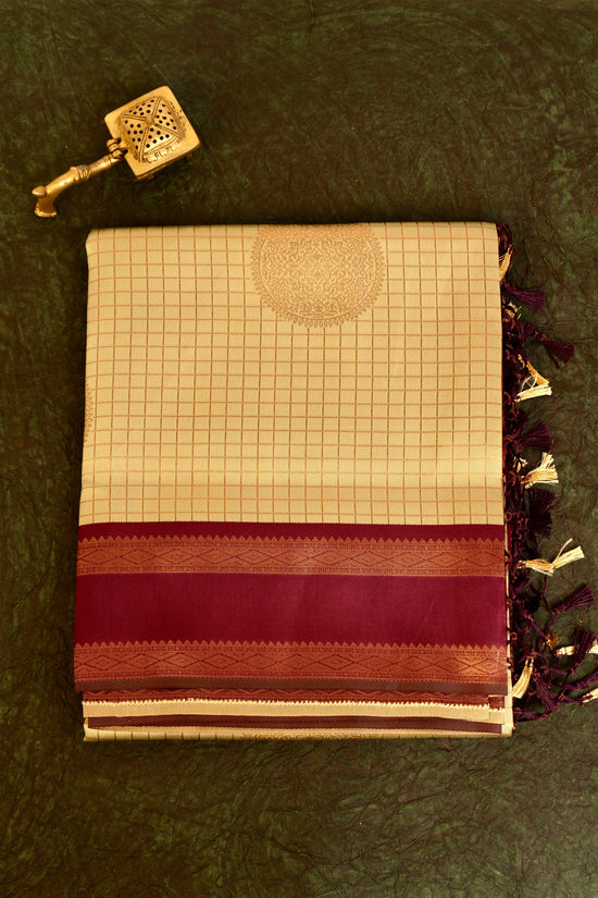 Designer saree in pale yellow with gold zari