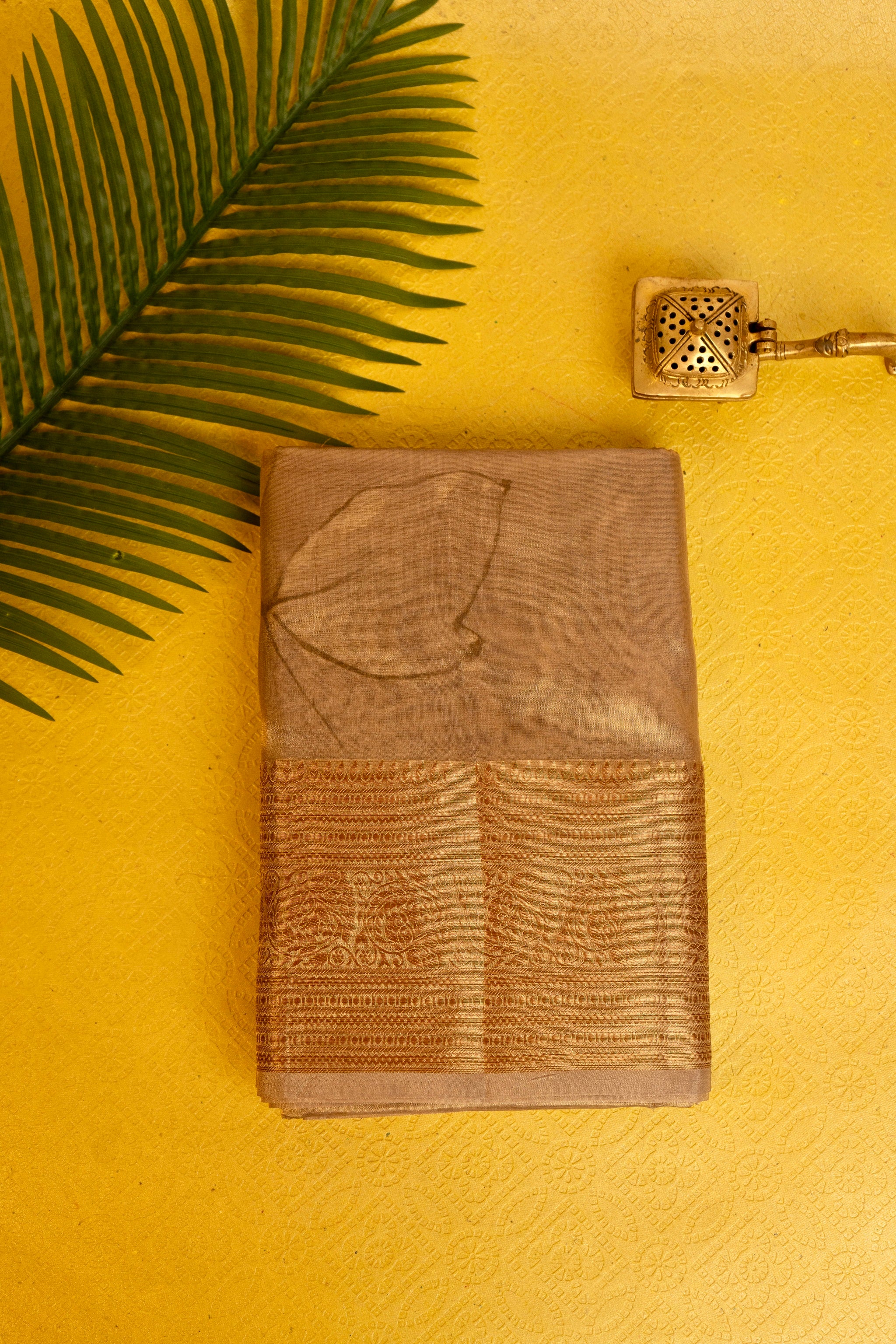 Designer saree in brown gold with floral paisley motifs
