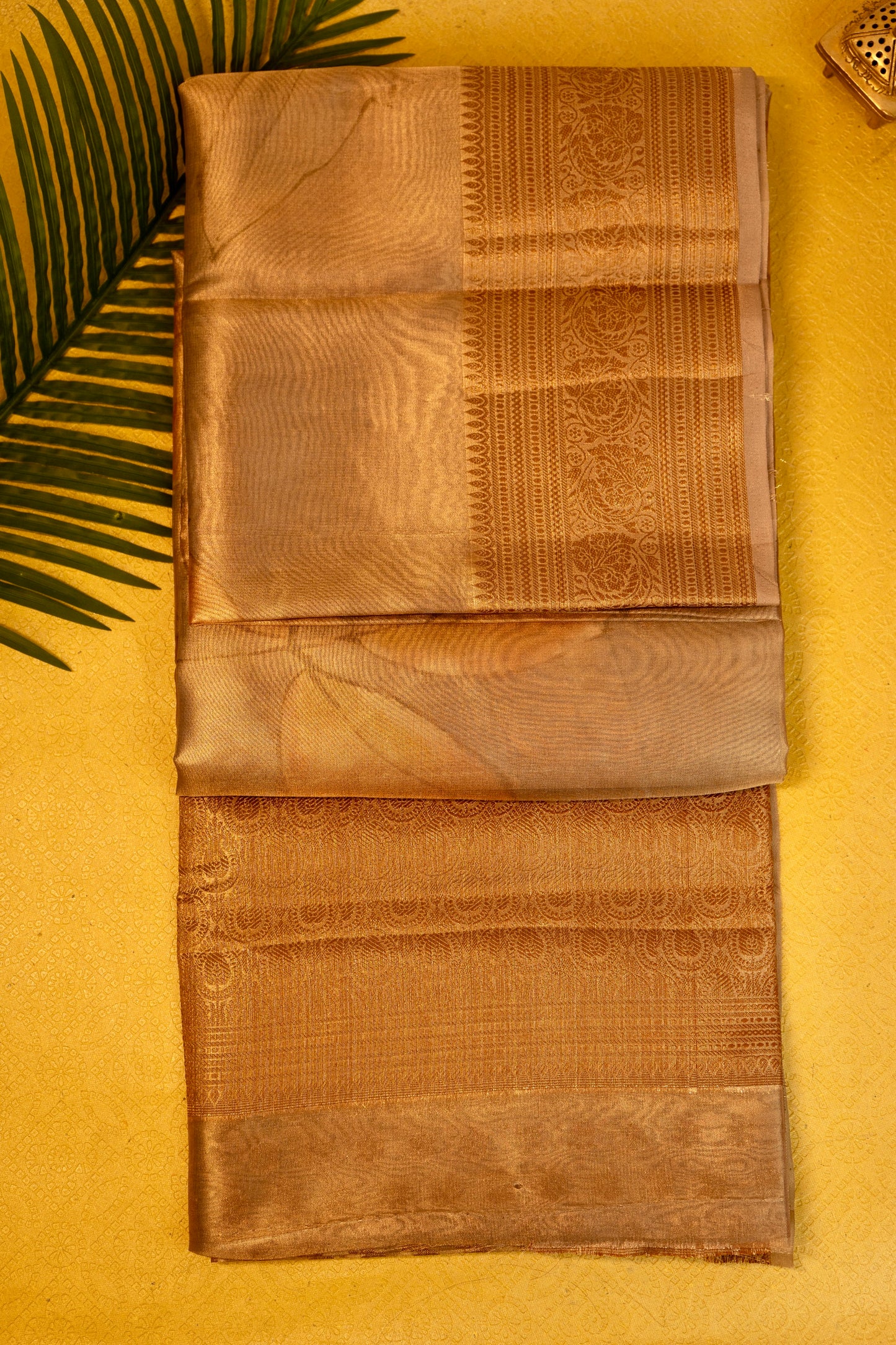Designer saree in brown gold with floral paisley motifs