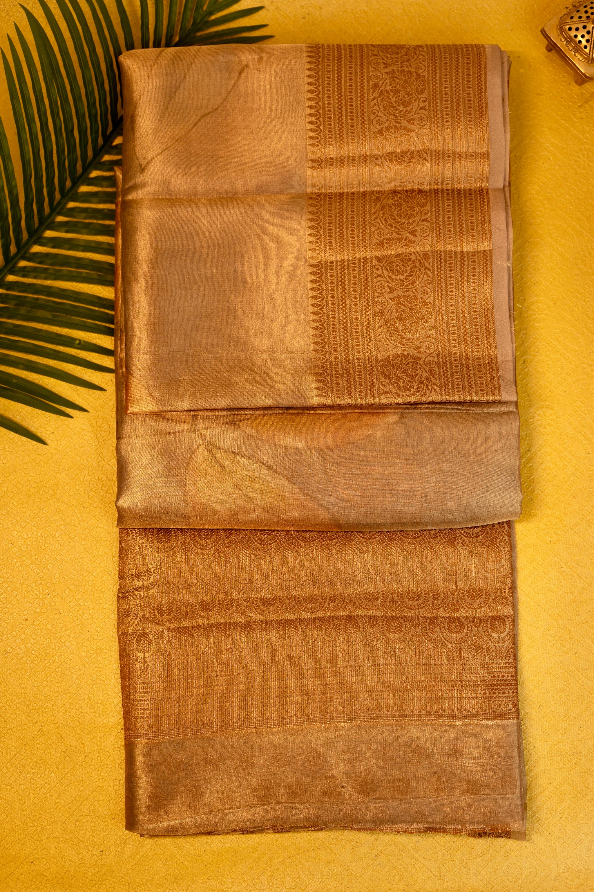 Designer saree in brown gold with floral paisley motifs