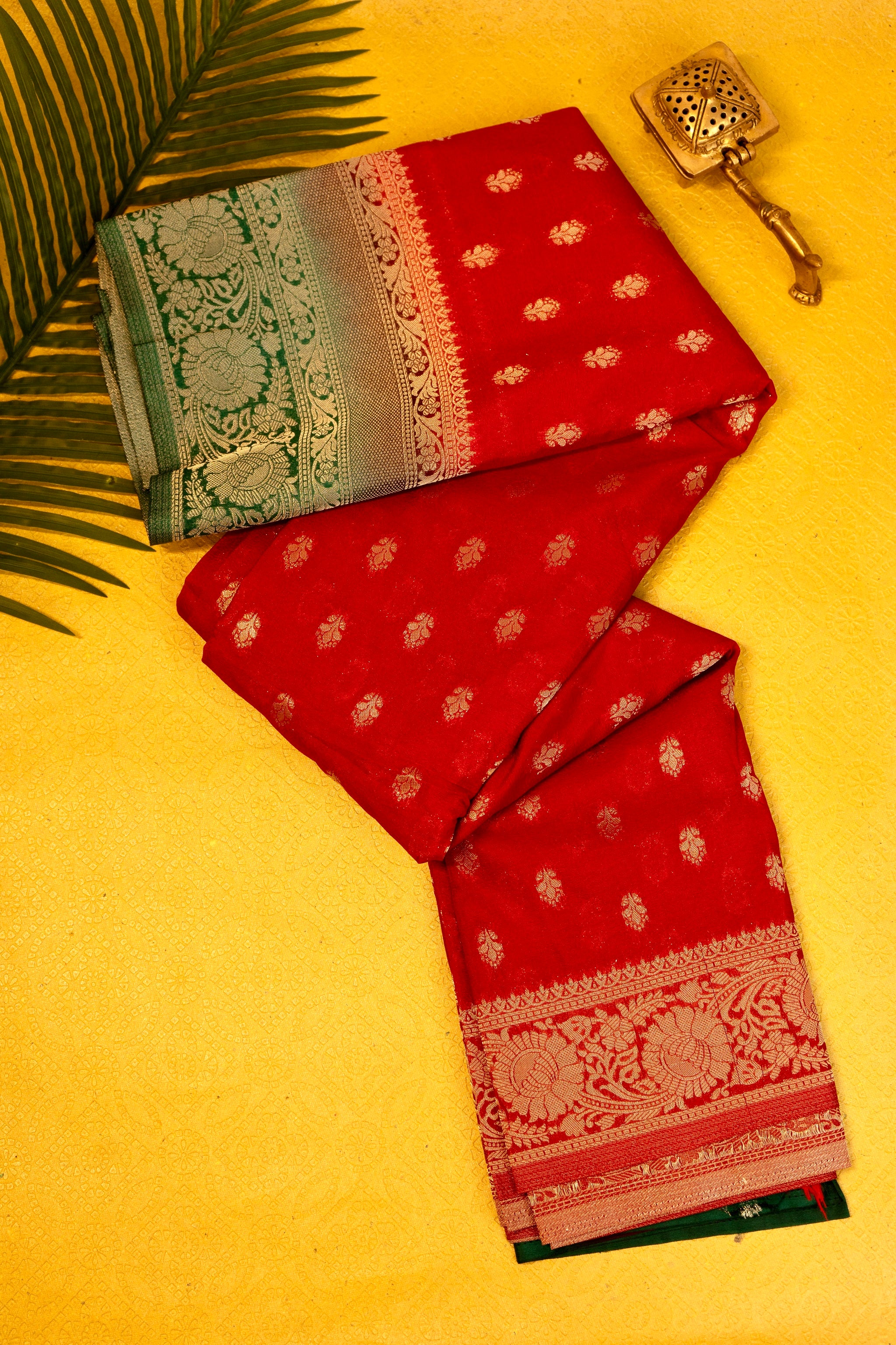 Designer saree in red with woven green motifs